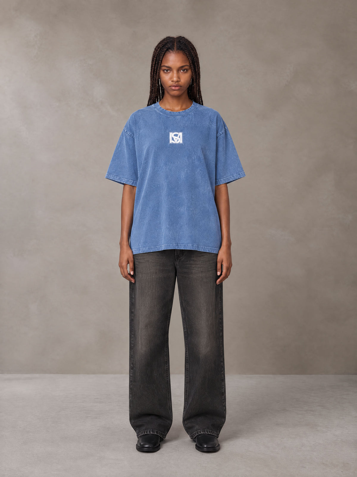 Model wearing the SM Acid Wash T-shirt in Soft Blue, front view.