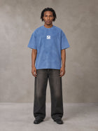 Model wearing the SM Acid Wash T-shirt in Soft Blue, front view.