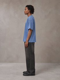 Model wearing the SM Acid Wash T-shirt in Soft Blue, side profile.