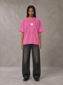 Model wearing the SM Acid Wash T-shirt in Vivid Pink, front view.