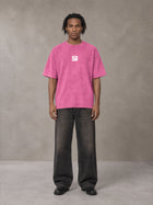 Model wearing the SM Acid Wash T-shirt in Vivid Pink, front view.