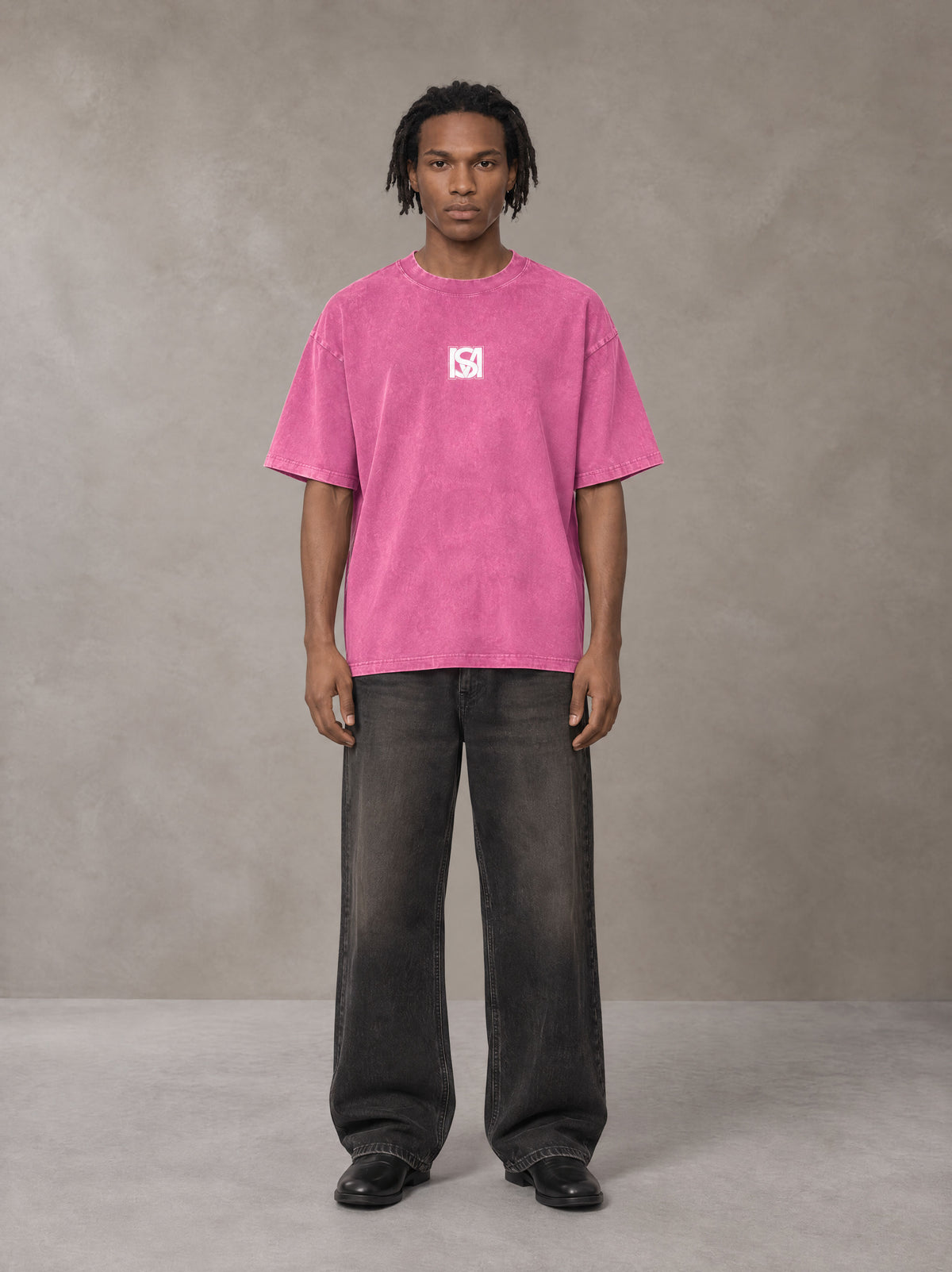 Model wearing the SM Acid Wash T-shirt in Vivid Pink, front view.