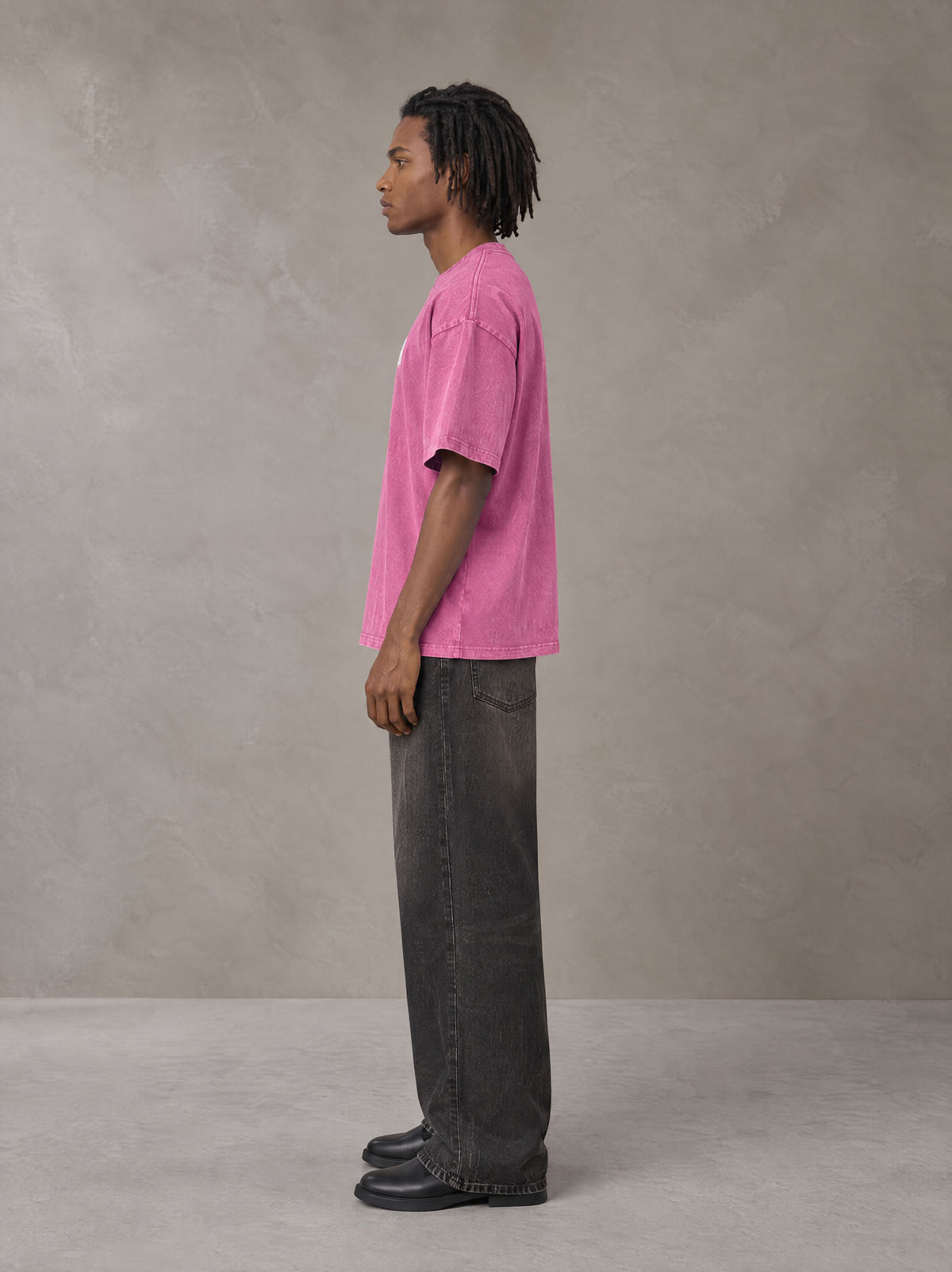Model wearing the SM Acid Wash T-shirt in Vivid Pink, side profile.