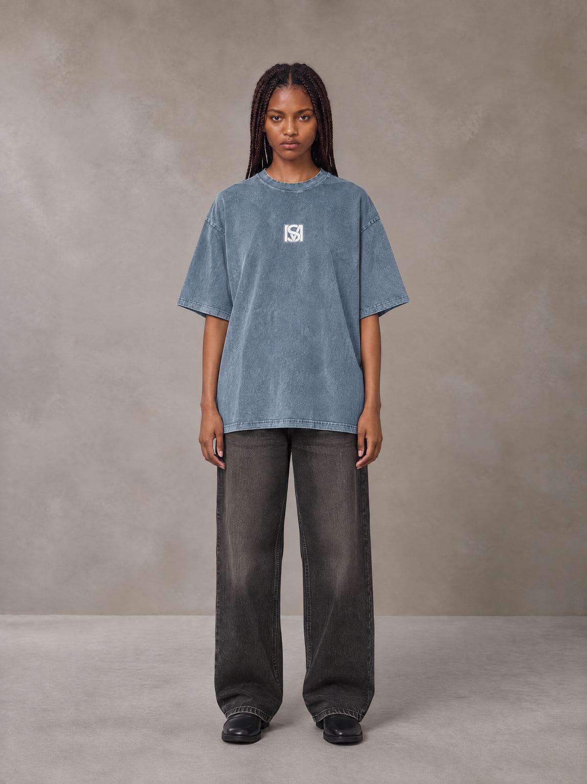 Model wearing the SM Acid Wash T-shirt in Washed Blue Jean, front view.