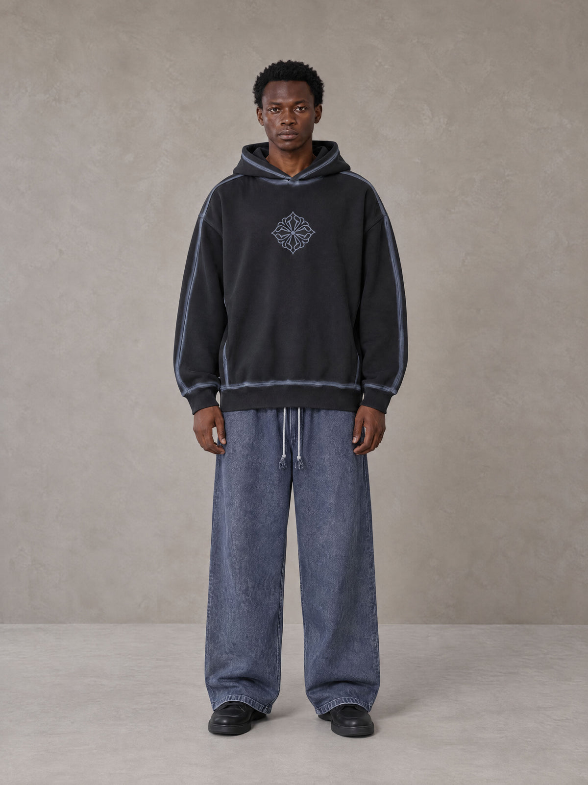 Model wearing the SM Acid Wash Trousers in Deep Denim, front view.