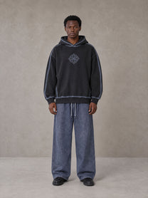 Model wearing the SM Acid Wash Trousers in Deep Denim, front view.