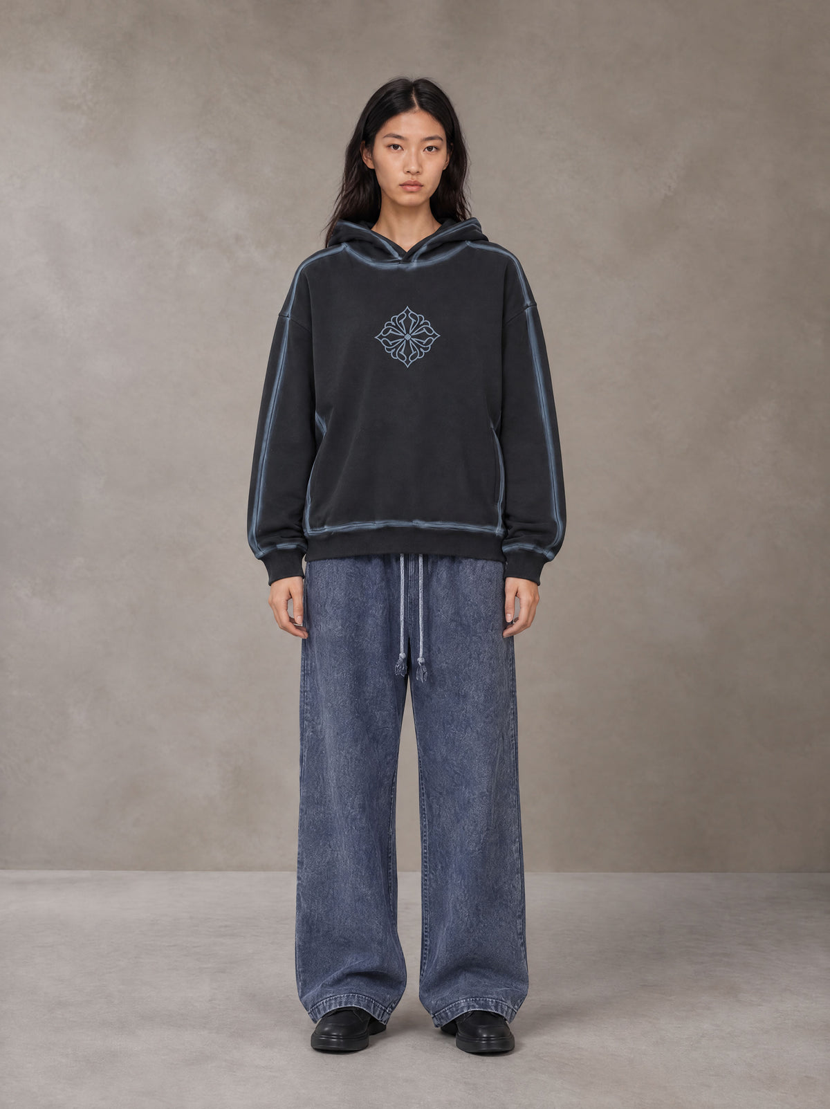 Model wearing the SM Acid Wash Trousers in Deep Denim, front view.