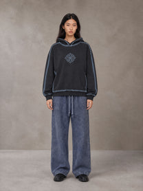 Model wearing the SM Acid Wash Trousers in Deep Denim, front view.