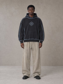 Model wearing the SM Acid Wash Trousers in Stone Grey, front view.