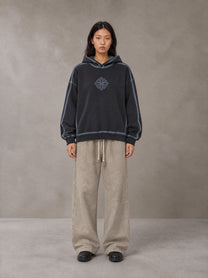 Model wearing the SM Acid Wash Trousers in Stone Grey, front view.
