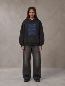 Model wearing the SM Baroque Bloom Hoodie in Midnight Black, front view.