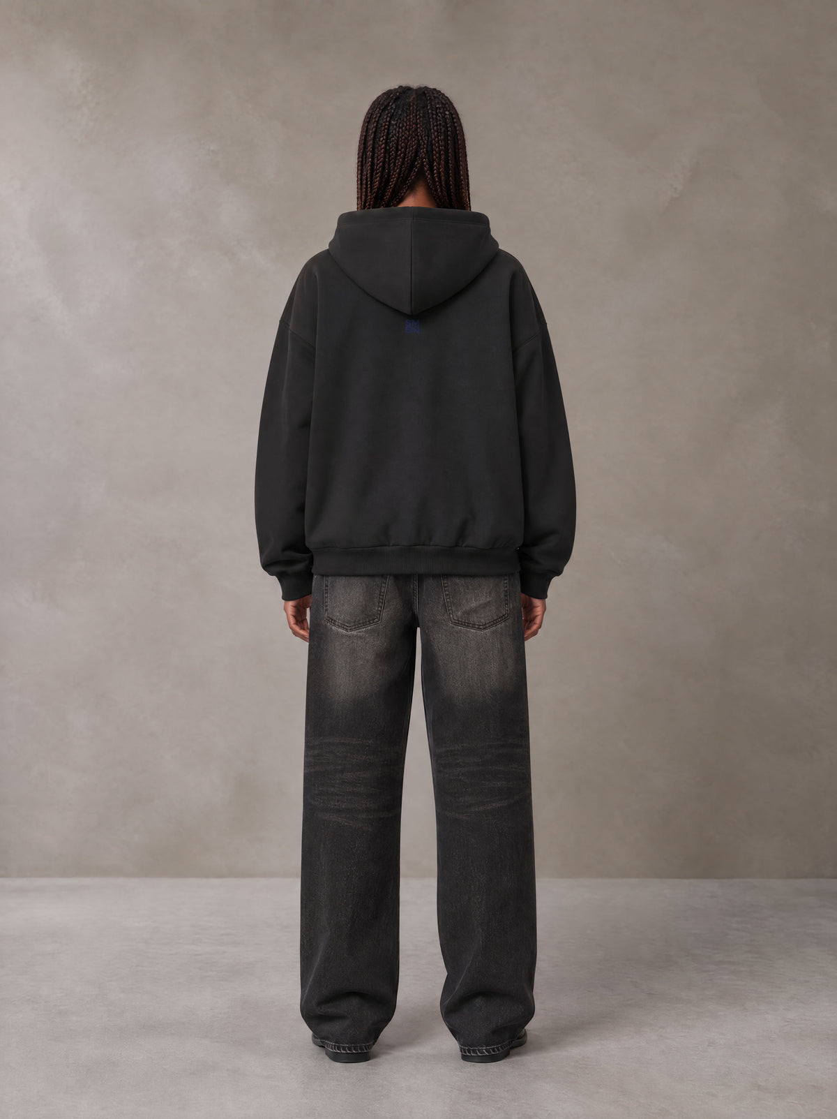 Model wearing the SM Baroque Bloom Hoodie in Midnight Black, rear view.