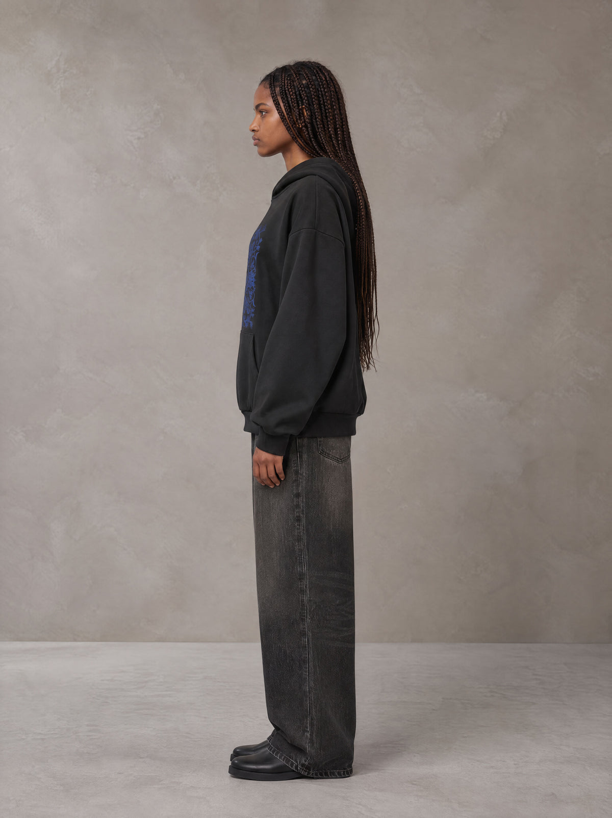 Model wearing the SM Baroque Bloom Hoodie in Midnight Black, side profile.