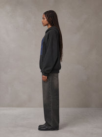 Model wearing the SM Baroque Bloom Hoodie in Midnight Black, side profile.