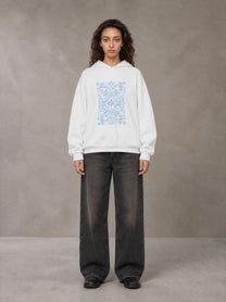 Model wearing the SM Baroque Bloom Hoodie in Lucent White, front view.