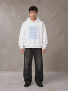 Model wearing the SM Baroque Bloom Hoodie in Lucent White, front view.
