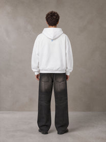 Model wearing the SM Baroque Bloom Hoodie in Lucent White, rear view.