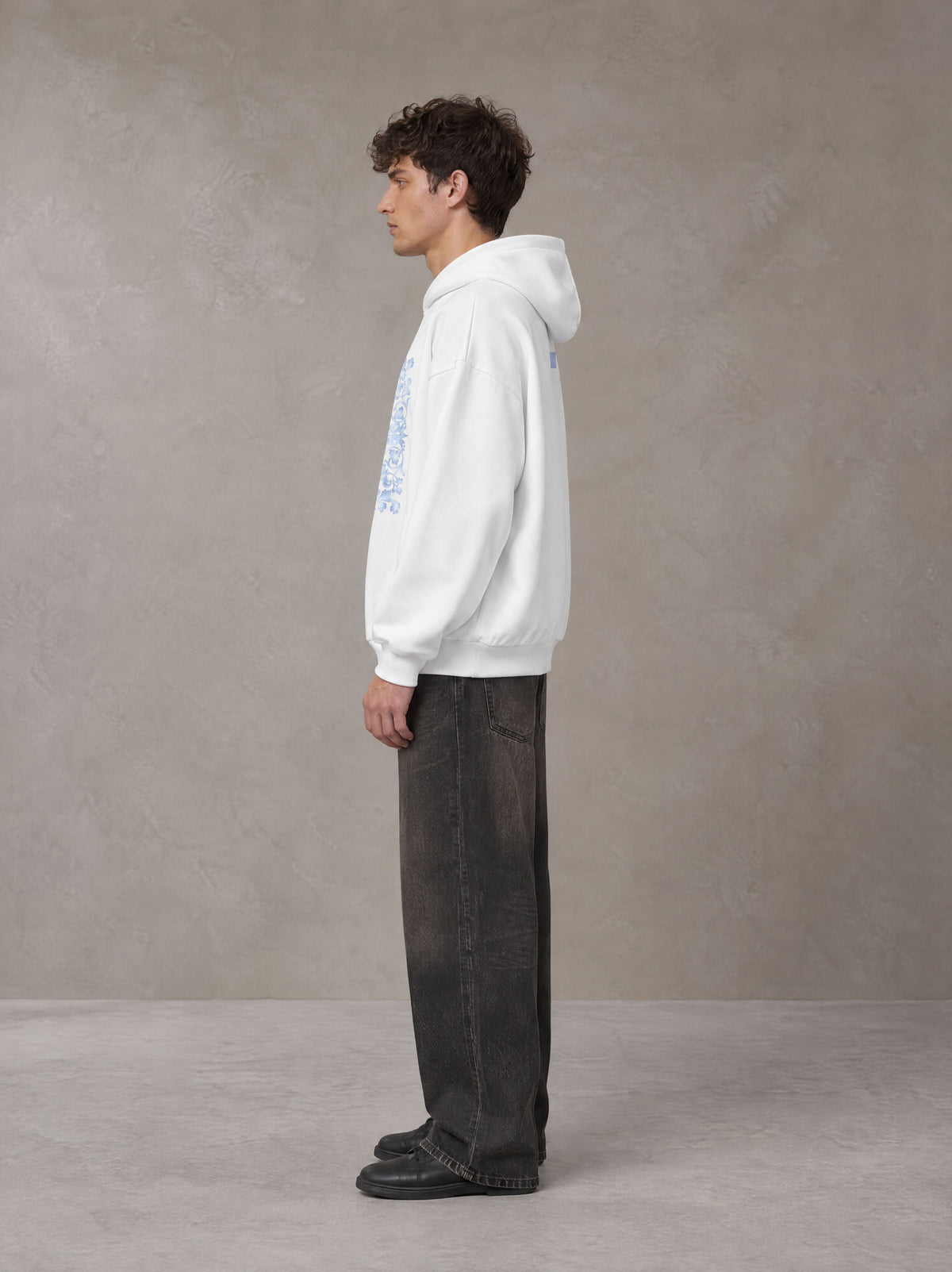 Model wearing the SM Baroque Bloom Hoodie in Lucent White, side profile.