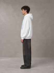 Model wearing the SM Baroque Bloom Hoodie in Lucent White, side profile.