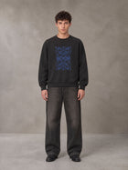 Model wearing the SM Baroque Bloom Sweatshirt in Midnight Black, front view.
