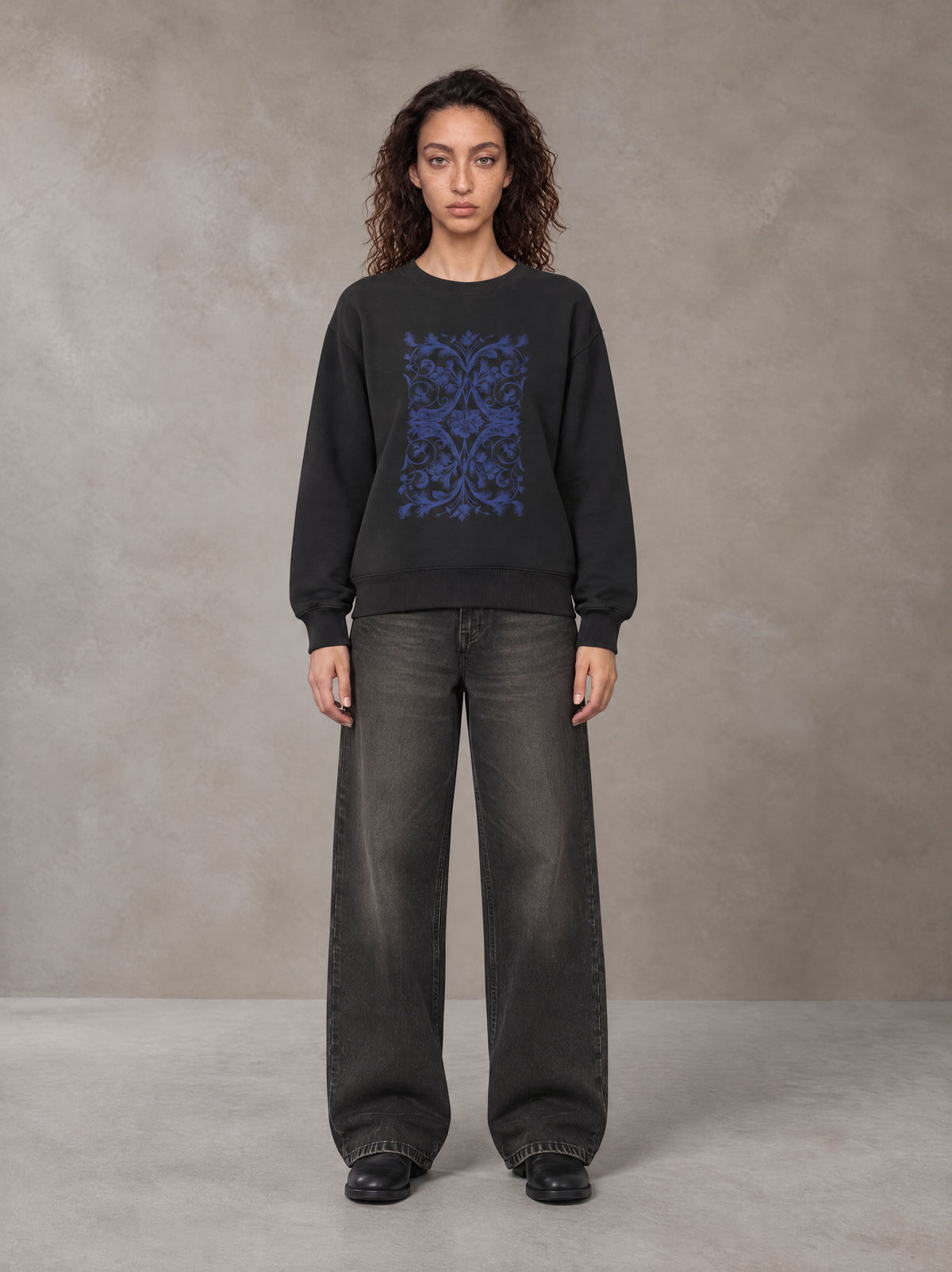 Model wearing the SM Baroque Bloom Sweatshirt in Midnight Black, front view.