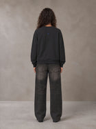 Model wearing the SM Baroque Bloom Sweatshirt in Midnight Black, rear view.