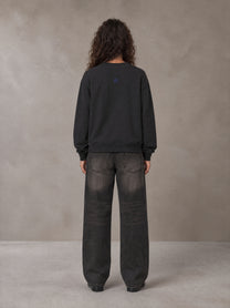 Model wearing the SM Baroque Bloom Sweatshirt in Midnight Black, rear view.