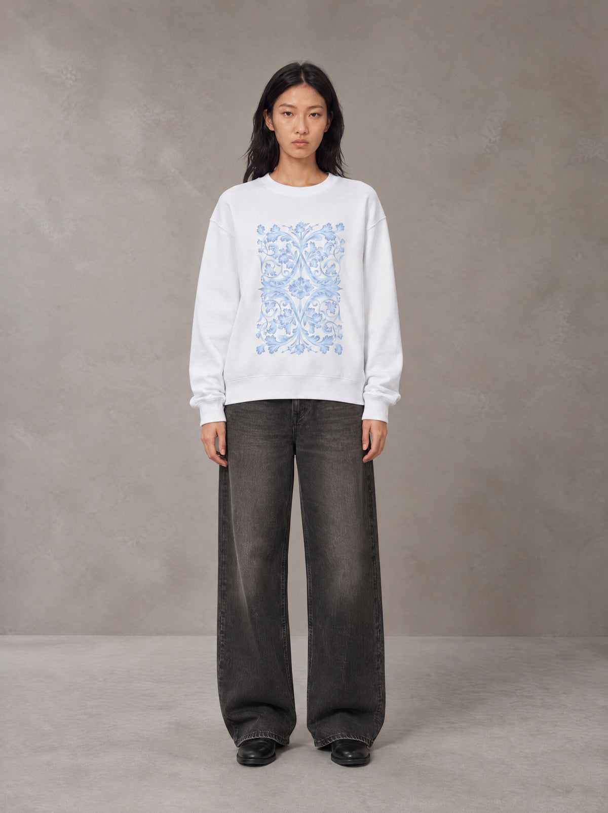 Model wearing the SM Baroque Bloom Sweatshirt in Lucent White, front view.