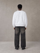 Model wearing the SM Baroque Bloom Sweatshirt in Lucent White, rear view.