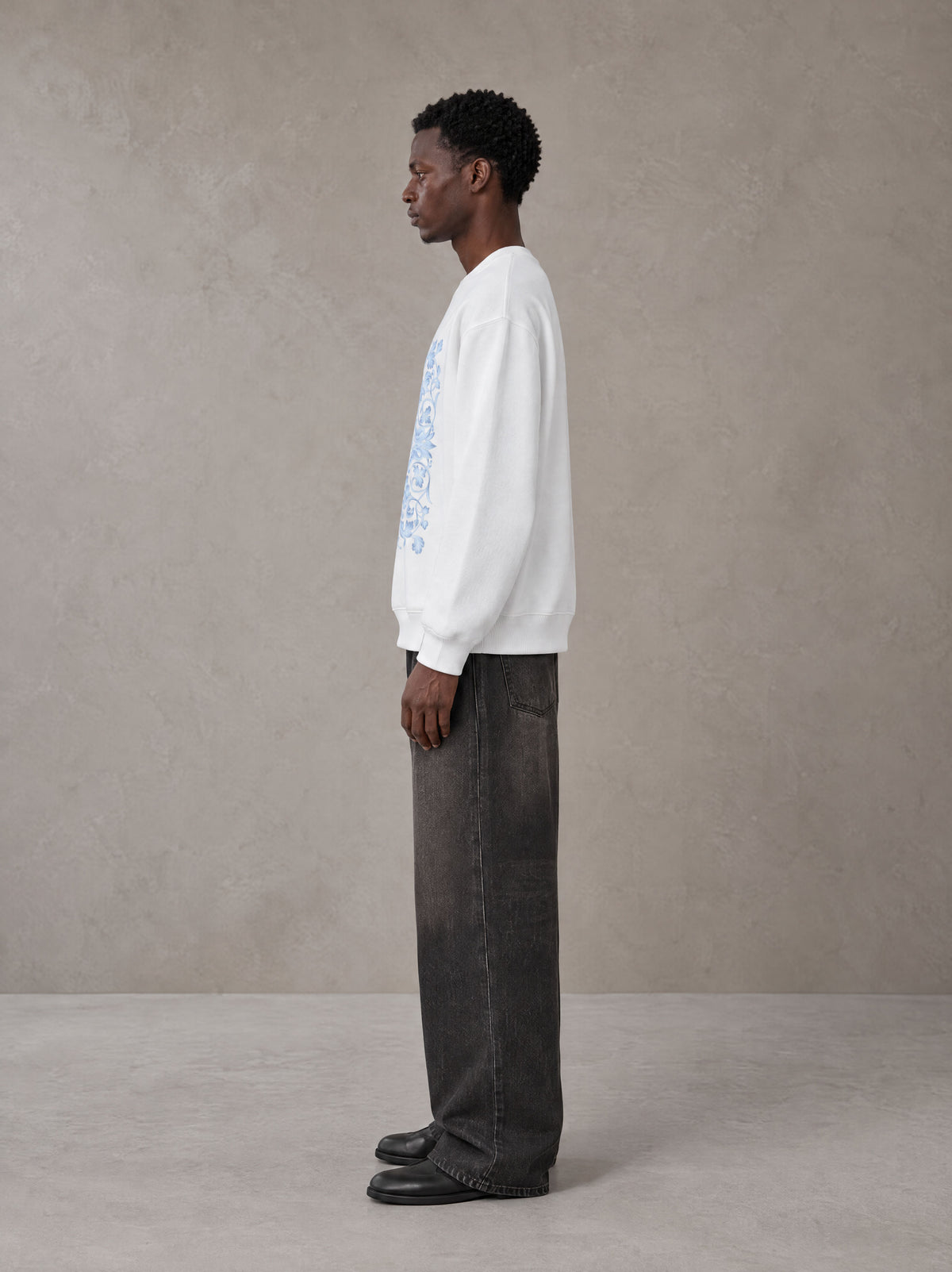 Model wearing the SM Baroque Bloom Sweatshirt in Lucent White, side profile.