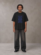 Model wearing the SM Baroque Bloom T-shirt in Midnight Black, front view.