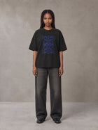 Model wearing the SM Baroque Bloom T-shirt in Midnight Black, front view.
