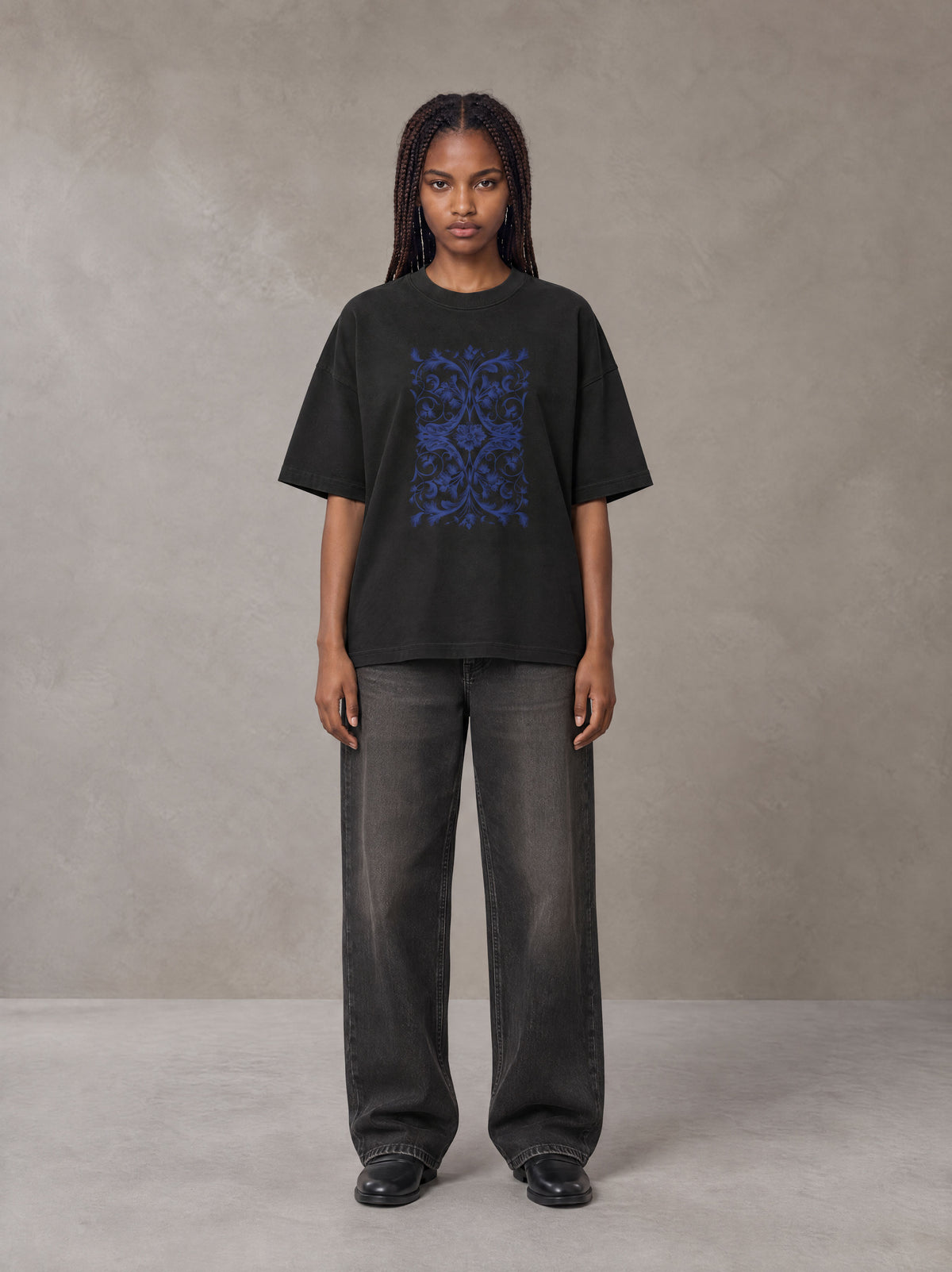 Model wearing the SM Baroque Bloom T-shirt in Midnight Black, front view.