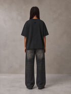 Model wearing the SM Baroque Bloom T-shirt in Midnight Black, rear view.