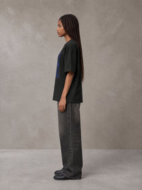 Model wearing the SM Baroque Bloom T-shirt in Midnight Black, side profile.