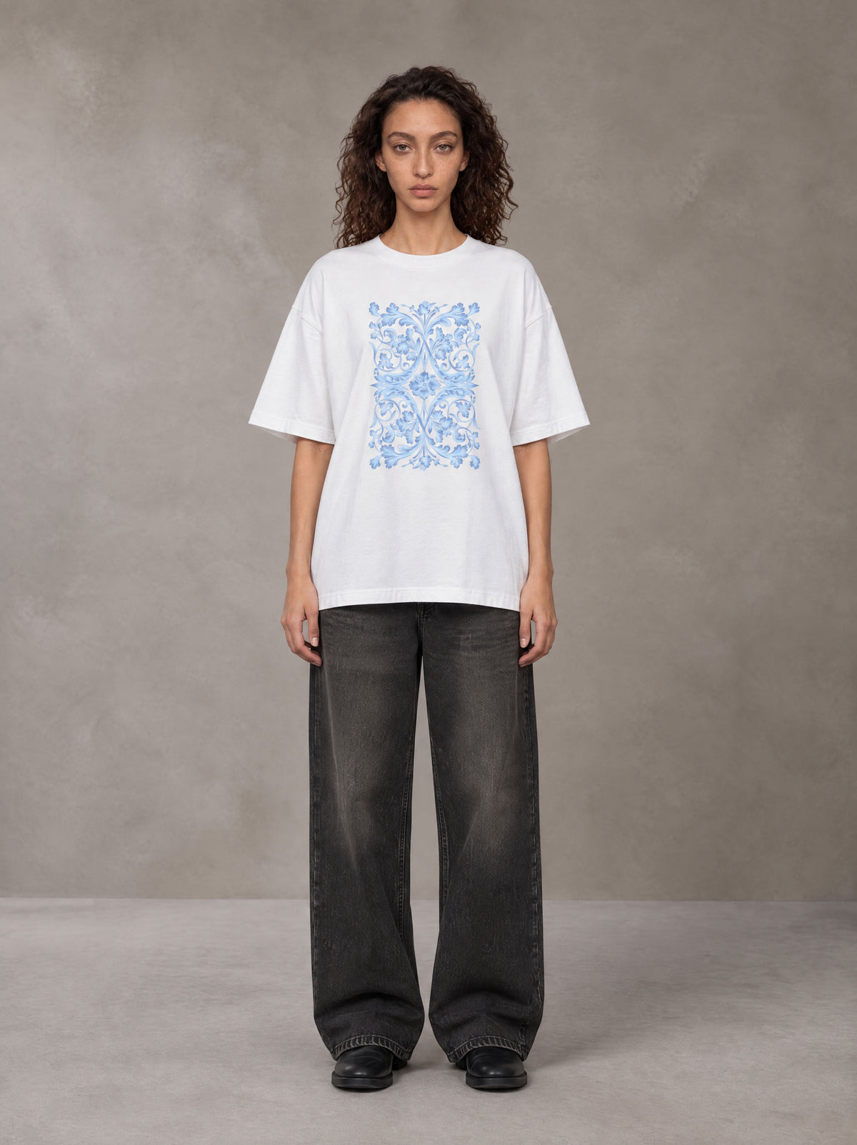 Model wearing the SM Baroque Bloom T-shirt in Lucent White, front view.