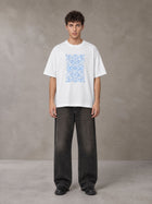 Model wearing the SM Baroque Bloom T-shirt in Lucent White, front view.