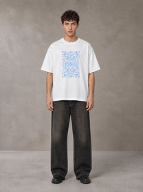 Model wearing the SM Baroque Bloom T-shirt in Lucent White, front view.