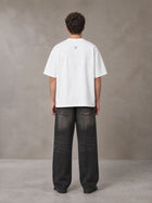 Model wearing the SM Baroque Bloom T-shirt in Lucent White, rear view.