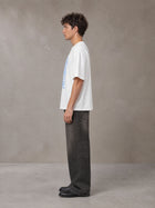 Model wearing the SM Baroque Bloom T-shirt in Lucent White, side profile.