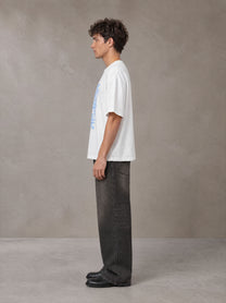 Model wearing the SM Baroque Bloom T-shirt in Lucent White, side profile.