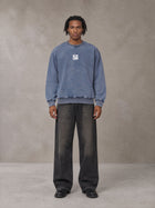 Model wearing the SM Denim Wash Sweatshirt in Chambray, front view.
