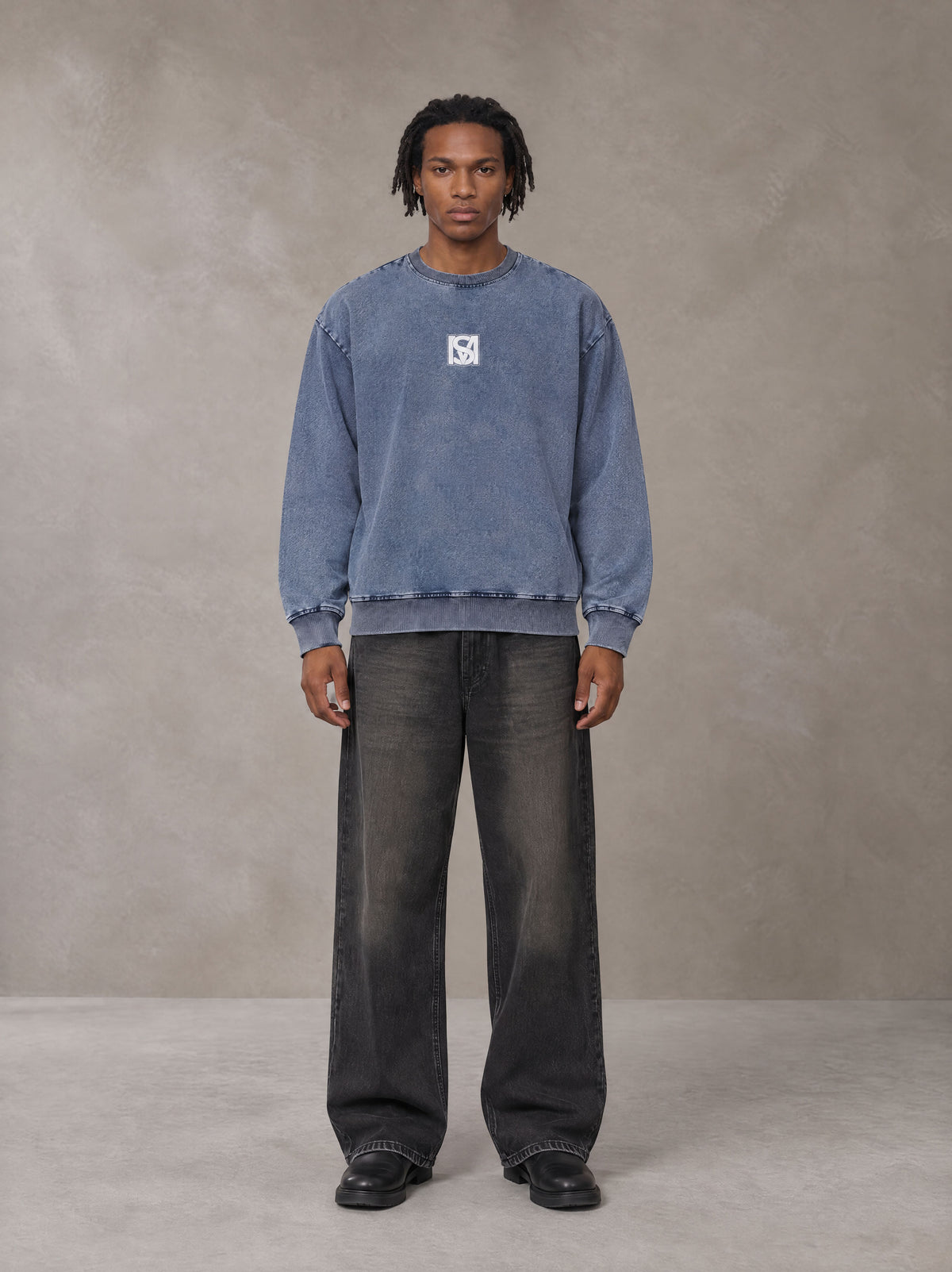 Model wearing the SM Denim Wash Sweatshirt in Chambray, front view.