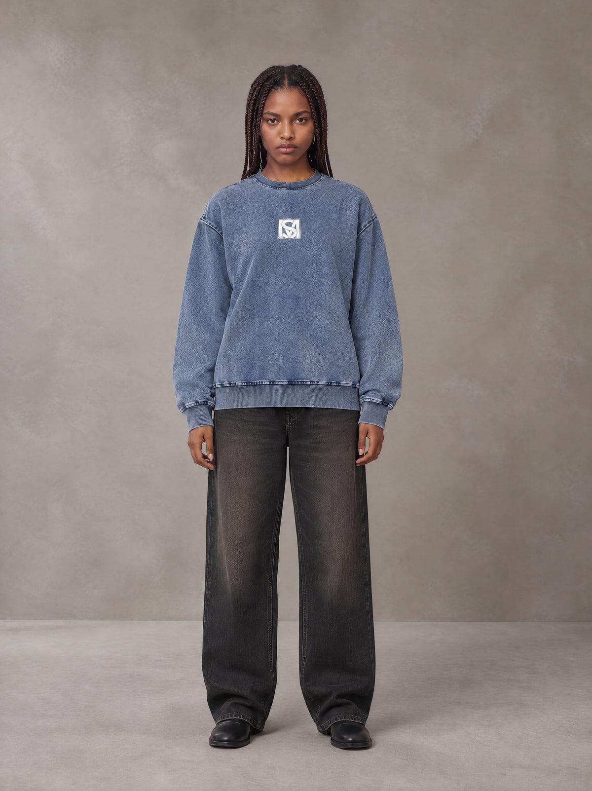 Model wearing the SM Denim Wash Sweatshirt in Chambray, front view.