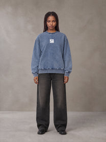 Model wearing the SM Denim Wash Sweatshirt in Chambray, front view.
