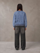 Model wearing the SM Denim Wash Sweatshirt in Chambray, rear view.