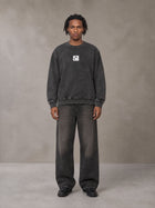 Model wearing the SM Denim Wash Sweatshirt in Midnight Black, front view.