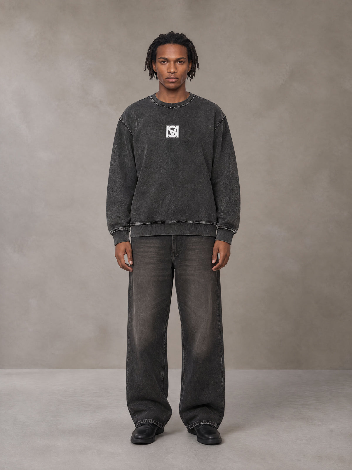 Model wearing the SM Denim Wash Sweatshirt in Midnight Black, front view.