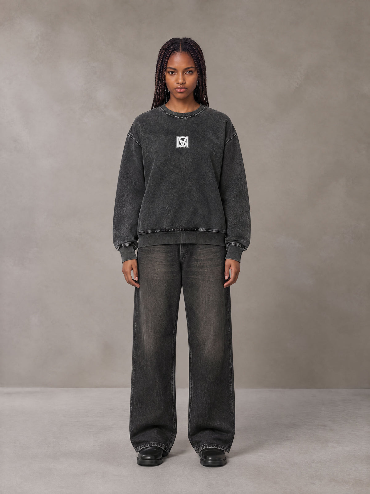 Model wearing the SM Denim Wash Sweatshirt in Midnight Black, front view.