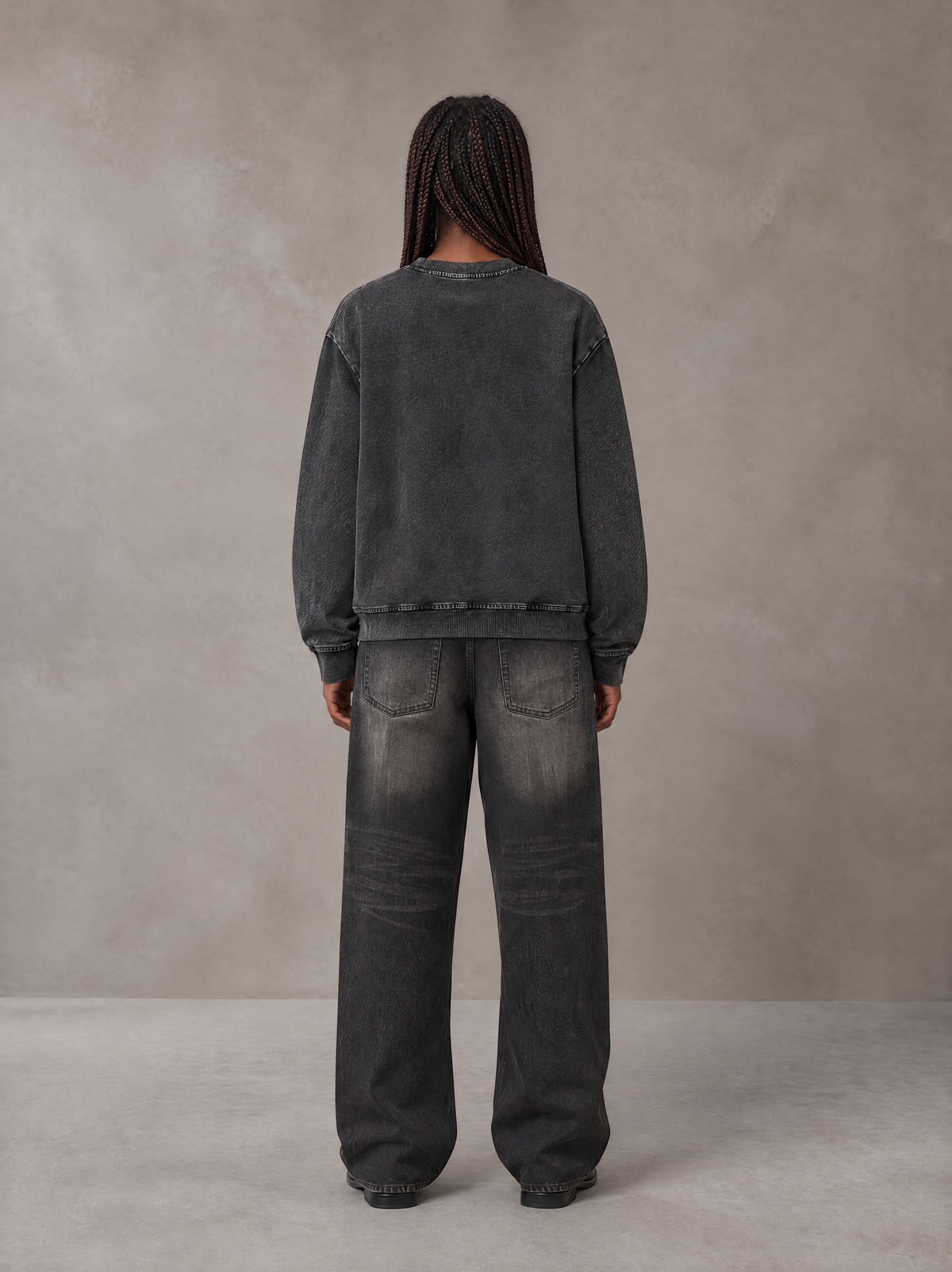 Model wearing the SM Denim Wash Sweatshirt in Midnight Black, rear view.
